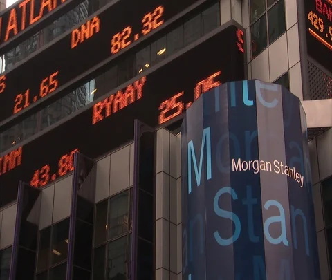 MS of blue Morgan Stanley sign and LED stock ticker on front of building. Stock Footage