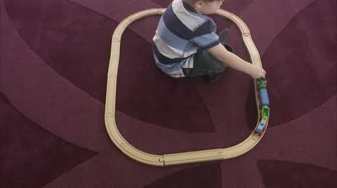 MS Boy (4-5) playing with miniature train Stock Footage 11339582