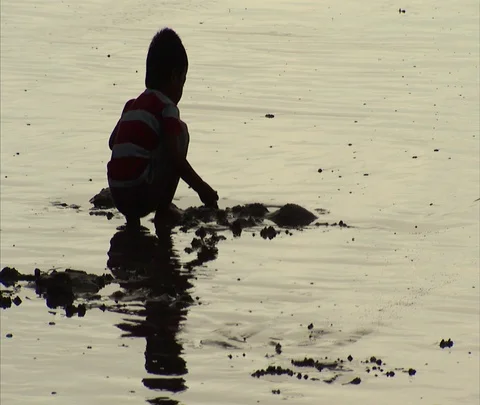 MS boy playing in wet sand on Kuta Beach Video stock 86747038