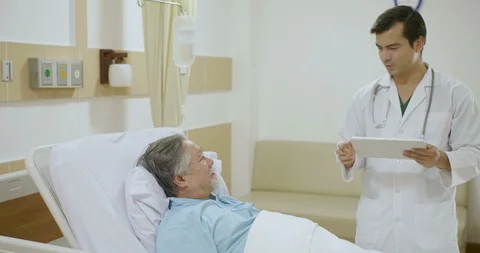 MS Doctor use digital tablet to telling to senior patient the results of his Video stock 91875470