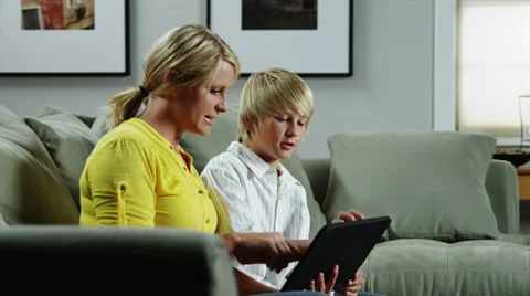 MS DS Mother and son (10-11) using ipad on sofa / Orem, Utah, USA Stock Footage 38835686