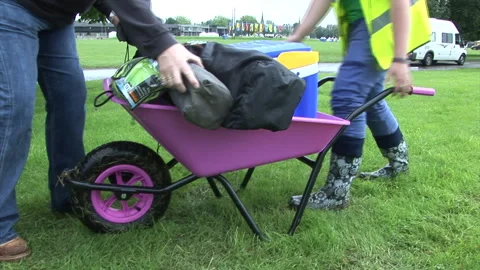 MS Handheld shot of Pink Wheelbarrow being loaded with items Stock Footage 273246640