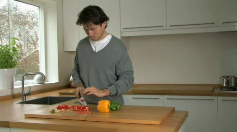 MS OF A MAN CHOPPING PEPPERS Stock Footage 542129