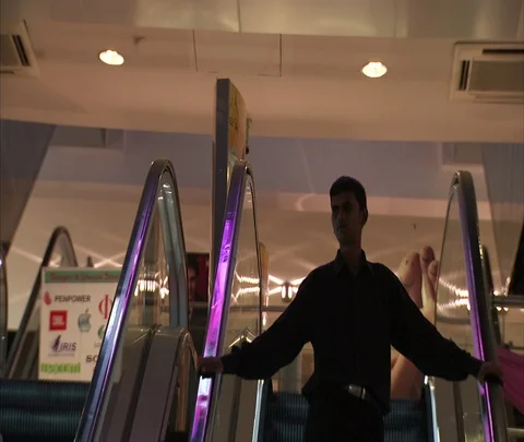 MS man descending on escalator inside Atria Mall. Stock Footage 86742448