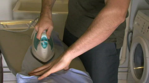 MS OF A MAN IRONING Stock Footage 542585