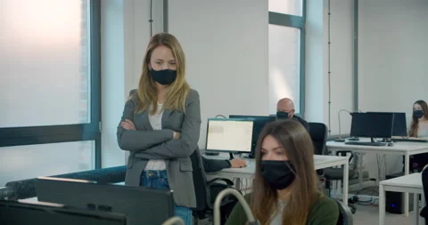 MS Manager watching over office workers wearing face masks during pandemic Stock-Footage 145146333