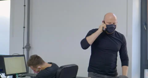 MS Office worker wearing protective face mask and talking on phone Stock-Footage 145203753