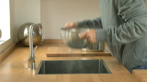 MS PAN OF A MAN DRAINING PASTA Stock Footage 542263