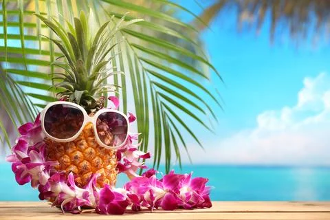 Ms pineapple on beach table Stock Photos