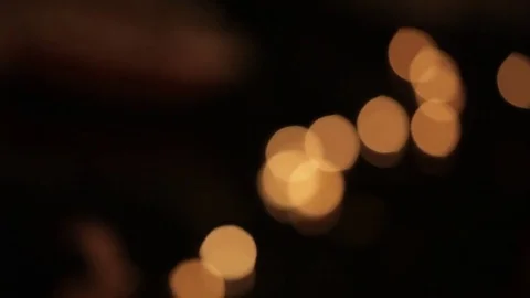 MS R/F Illuminated offerings floating down river Ganges at night / Varanasi, Stock Footage 69962649