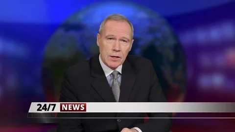 MS senior male anchor speaking at news desk in television studio Stock Footage