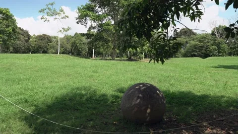 MS single sphere in grass, mounds of village in background Stock Footage 206502397