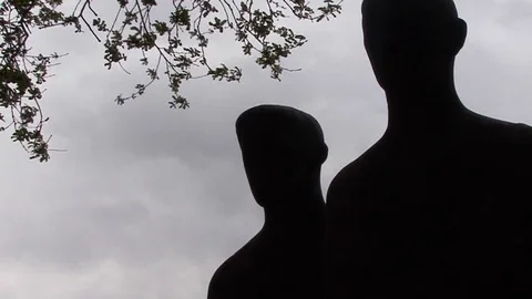 MS Soldier Statues in Shadow and Tree Branches at Langemark German War Cemetery Stock-Footage 98033221
