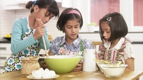 MS Three girls preparing cake Stock Footage 11342132