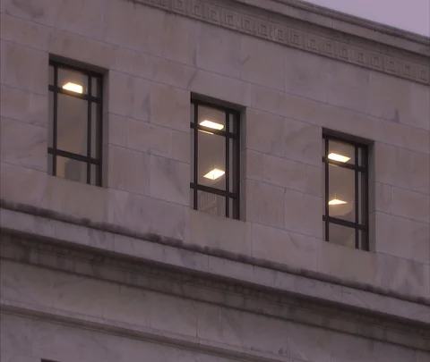 MS three windows at dusk, zoom in to one window with lights on Stock Footage 86749792