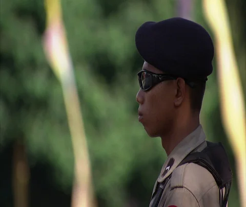 MS tilt down armed soldier in front of Bali International Conference Center Stock Footage 86747000