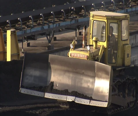 MS tractor pushing coal over coal pile outside of Shenhua Sanhe power station Stock Footage 86746677