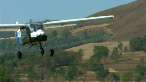 MS TS Light aircraft taking off with hills behind / Howick, KwaZulu-Natal Video stock 95598558