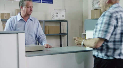 MS TU Elderly man picking up parcel at post office / Orem, Utah, USA Stock Footage 38833651
