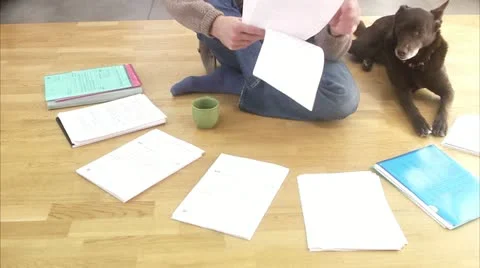 MS TU Man sitting on floor holding document Stock Footage 11291308