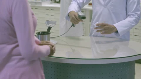 MS TU Pharmacist scanning bar code through bar code reader Video stock 31956709