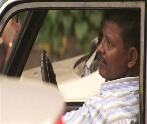 MS two men waiting in car as pedestrians cross the street. Stock Footage 86742333