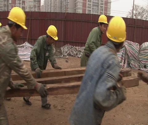 MS workers in hard hats pushing cart on construction site Stock Footage 86744253