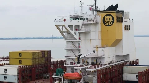 Msc letizia’s towering white superstructure yellow funnel marked logo stacked Stock Footage 328204169