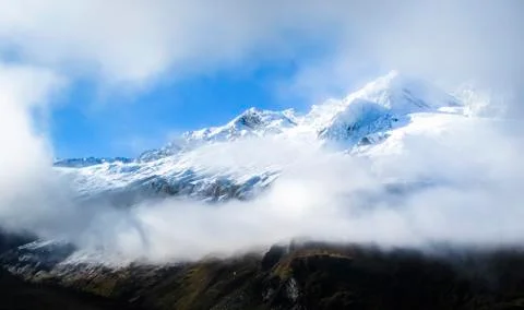 Mt. Aspiring is seen through a gap in the clouds in New Zealand Stock Photos
