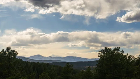 Mt Evans Blue Sky Timelapse spring time clouds rolling over mountain Stock Footage 238987328