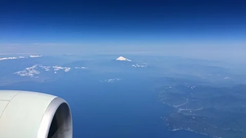 Mt fuji from airplane with engine in foreground air travel Stock Footage 124571144