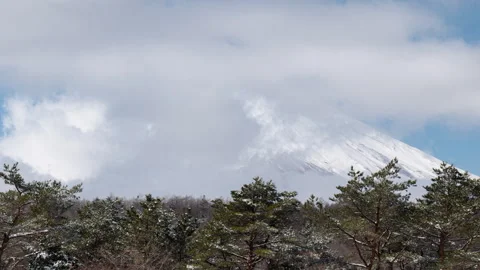 Mt. Fuji Emerging from Clouds after the Snow (Timelapse | ZOOM OUT) Stock Footage 303890590