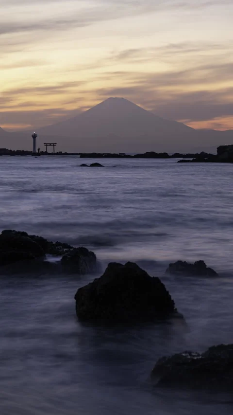 Mt. Fuji over Lighthouse and Tori Gate at Sea (Vertical Timelapse/Static) Stock Footage 328383111