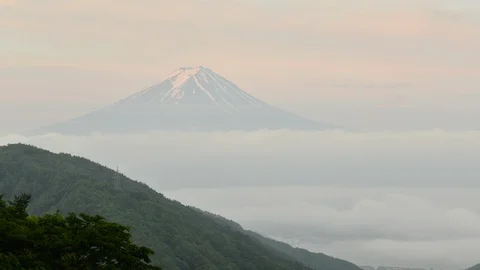 Mt. Fuji over a Sea of Clouds in a Cloudy Morning Stock Footage 86183990