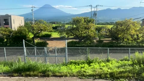 Mt. Fuji passing by while looking out from window of local train passing Stock Footage 345640863