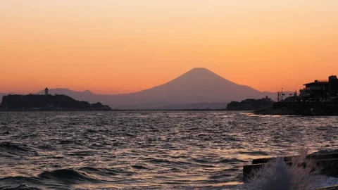 Mt Fuji with the sun setting off the coast of Kamakura Stock Footage