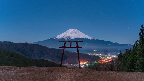 Mt Fuji with torii gate at night under fullmoon with stars Stock Footage 123581292