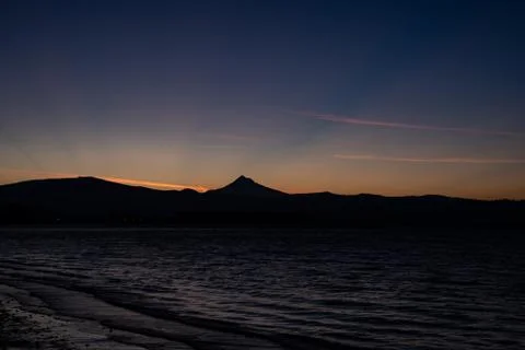 Mt Hood sunrise silhouette with sun rays along the Columbia River Stock Photos