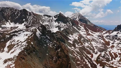 Mt Mount Lindsey Spring summer snow fields melting morning blue sky clouds Stock Footage 316400246