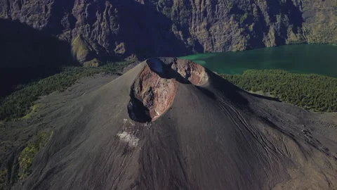 Mt. Rinjani top, close-up Mt. Barujari volcanic cone in crater lake, aerial view Stock Footage 316130923
