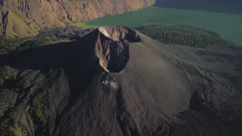 Mt. Rinjani top, close-up Mt. Barujari volcanic cone in crater lake, aerial view Stock Footage 316131867