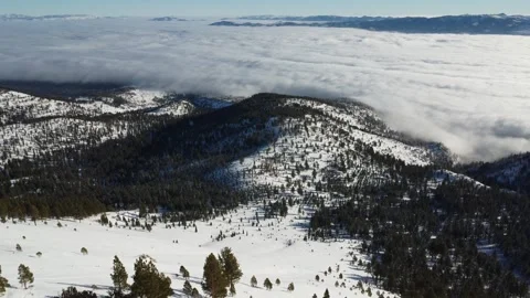 Mt Rose in Winter with snow and cloud inversion over Reno, Nevada - Aerial Stock Footage 244698532