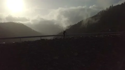 MTB rider over a dam side view Video stock 148337111