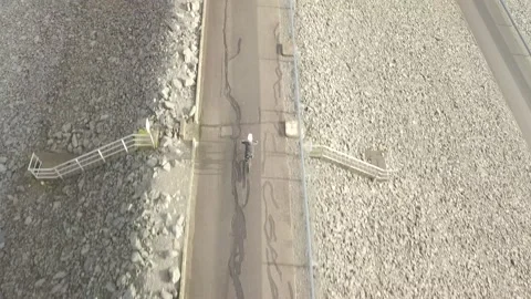 MTB rider over a dam top view Video stock 148336975