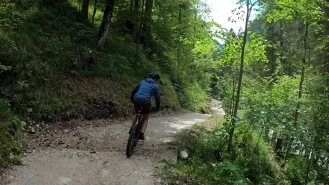 MTB riding down a Trail through a lush Forest, Austria Stock Footage 140849720