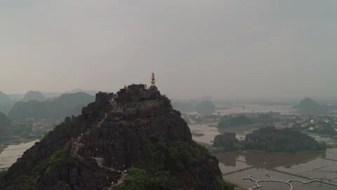 The Mua Cave viewpoint rises above limestone karst Ninh Binh, Vietnam Stock Footage 329797104