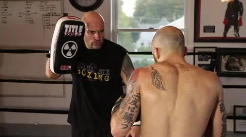 Muay Thai fighter practice his techniques with his coach with pads Stock Footage 22085033