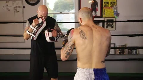 Muay Thai fighter practice his techniques with a coach Stock Footage 22085241