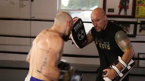 Muay Thai fighter practice technique with coach holding pads Stock Footage 22085044