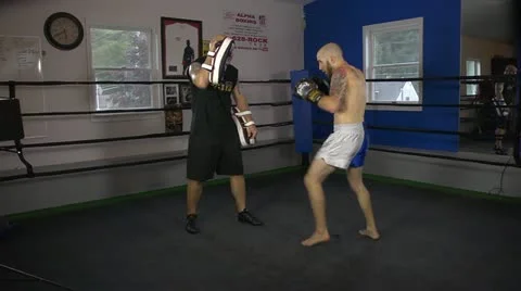 Muay Thai fighter practices his techniques with a coach Stock Footage 22085209